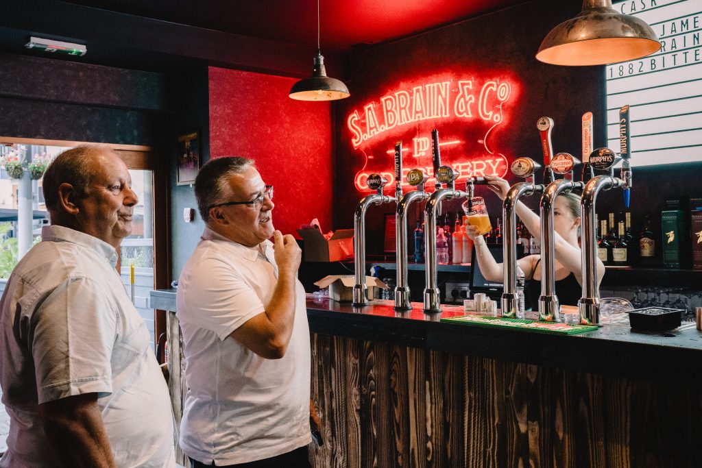 Customers at bar at The Old Brewery